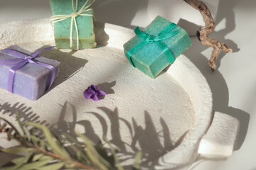 Cubes of natural soap against backdrop of natural elements. Handicrafts and hobbies. Cosmetics and beauty. Eco-friendly products. Background, composition for design.