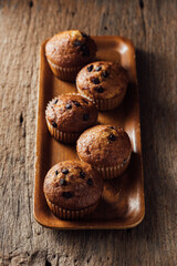 Freshly Baked Muffins on Wooden Tray with Rustic Background