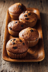 Freshly Baked Muffins with Chocolate Chips on Wooden Tray