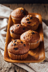 Freshly Baked Muffins with Chocolate Chips on Wooden Tray