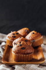 Freshly Baked Muffins with Chocolate Chips on Wooden Tray