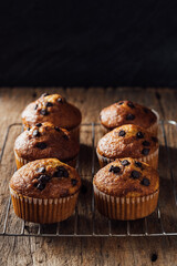 Freshly Baked Muffins with Chocolate Chips on Rustic Wooden Table