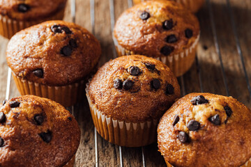 Freshly Baked Chocolate Chip Muffins on Rustic Wooden Surface