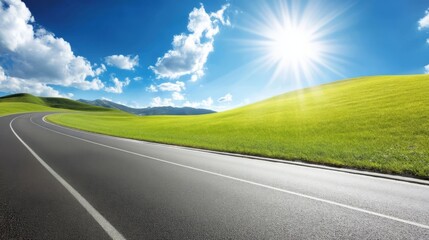 Expansive rural landscape with grazing damage, paved road winding through grassy hillsides and fields,