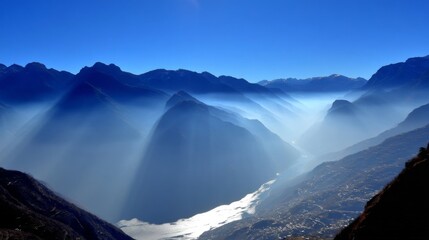 Serene blue mountainous landscape with towering peaks, winding river reflecting sunlight,