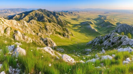 Vast mountain landscape bathed in golden light with rugged hills, sharp peaks, lush greenery, rocky outcrops,