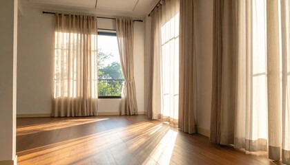 Obraz premium Sunlight streams through elegant, beige curtains, illuminating the warm wooden floor of an empty room.