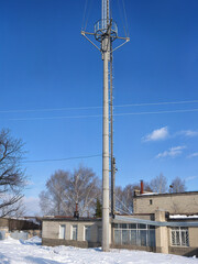 Communication tower against a clear blue winter sky