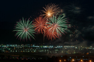 Fireworks in the night sky.  Colorful fireworks exploding in the night sky, with bright streaks of...