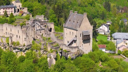larochette castle visitors green cover cloudy sky historical building beautiful town visible below circling aerial drone shot château fort de luxembourg  - Powered by Adobe