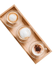 Three cups of coffee drinks on a wooden tray