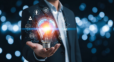 Businessman holding glowing light bulb with innovation and technology icons in hand