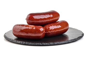 Sausages Stacked on Slate, isolated on white background