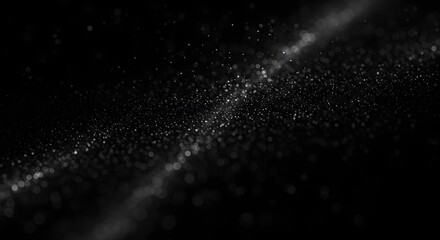 Abstract black and white image with shimmering particles and a blurred diagonal line