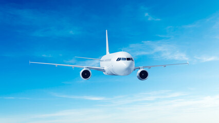 Obraz premium White airplane front view flying in the blue sky background. Modern passenger jet airplane.