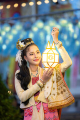 Asian women wearing thai dress with Lanna lantern at twilight in yi peng festival, Traditional thai...