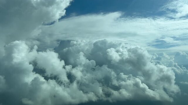 An immersive pilot&rsquo;s POV in a right turn while flying through threatening storm clouds in a turbulent anf bright blue sky. Footage taken from a jet cockpit.