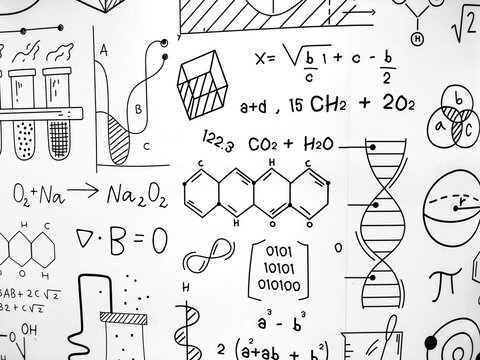 The whiteboard contains various mathematical formulas, scientific diagrams and equations hand-drawn with black marker. Education concept