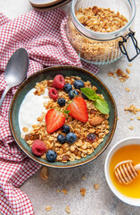 Granola yogurt parfait with fresh berries and honey