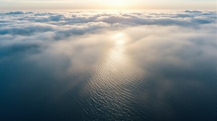 Aerial nature landscape with sun rays, clouds, and blue sky high above the ocean and horizon