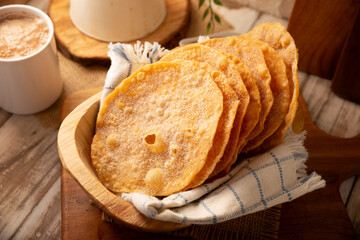 Mexican Buñuelos. Traditional food at Christmas and winter holidays in Mexico, these are fried flour tortillas sprinkled with sugar or covered in a syrup made with piloncillo, cinnamon, and guava.
