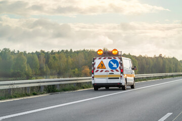 Highway patrol van driving past billboard