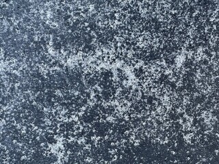 Texture of black paving slabs with white spots