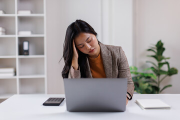 Stressed tired dizzy young lady, asian business woman employee office worker touching head feeling...