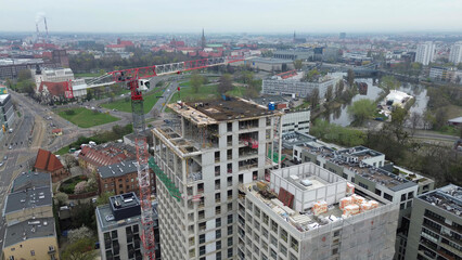 Obraz premium Modern building under construction with urban crane