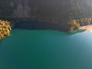 Lake Issyk in the rays of the setting sun. National Nature Park. Mountainous area with different vegetation.