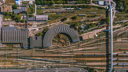 Aerial shot of a railway roundhouse and train yard. The radial pattern of the tracks displays both technical precision and visual rhythm. © Tibor.photo.Holczer