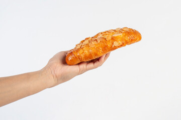 Fresh Rose Croissant with Almonds and hand on White Background