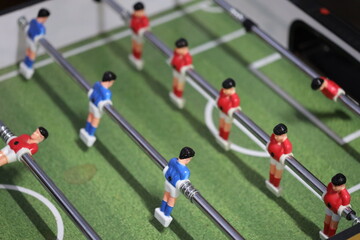 A tabletop foosball game with colorful figurines, perfect for indoor play or as decorative piece