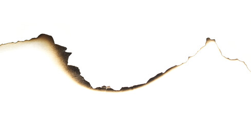 Black-brown burn marks on the edge of white paper