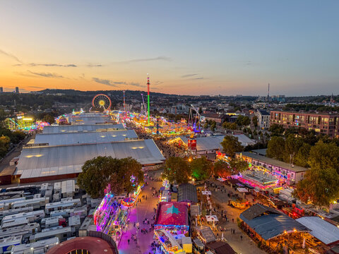 Birds eye view of carnival rides and festival crowd in stuttgart germany