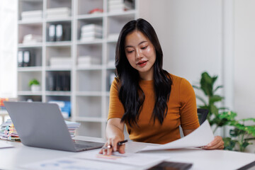 Business woman work on laptop and planning analyzing financial document data charts and graphs in...