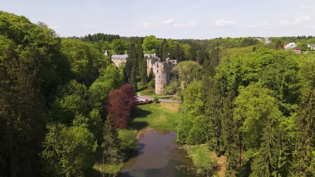 area medieval castle beaufort les ch teaux de green cover water body truck passing road luxembourg down downward drone shot old site fortress 