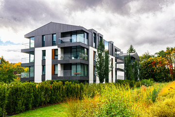 New modern residential block buildings and autumn park. Housing development in Europe	