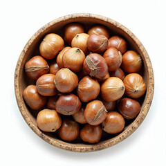 Obraz premium Hazelnuts in a wooden bowl on white background 