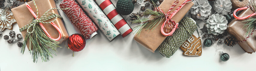 Festive Christmas gifts with wrapping paper and decorations on a white background