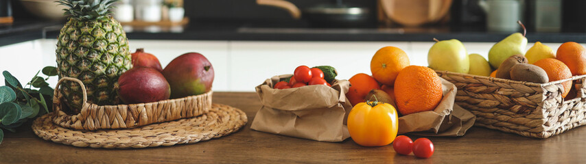 Fresh fruit and vegetables arranged on a wooden kitchen counter