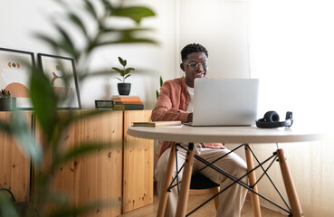 Young man working from home office using laptop computer