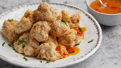Breaded cauliflower with orange sauce