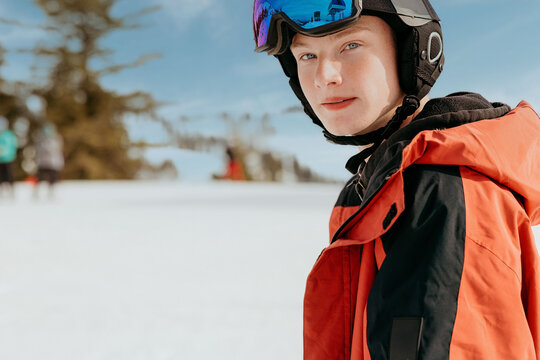 Close-up of snowboarder in red jacket and ski wear