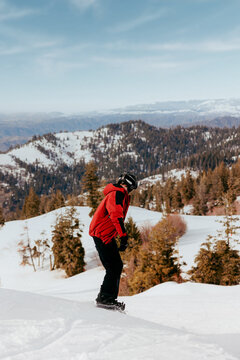 Snowboarder riding fresh powder on mountain slope