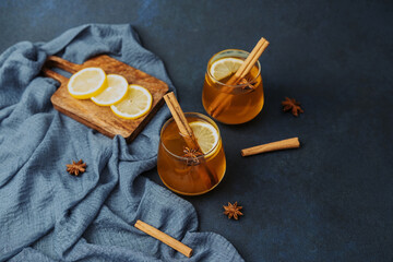 Hot drink with lemon slices and cinnamon sticks, star anise, simple ingredients © reddish