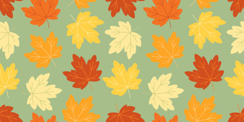 Bright seamless pattern with maple leaves in yellow, red, and orange on a green background. Cheerful fall design for prints, wallpapers, and seasonal graphics