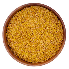 Isolated Bulgur in a wooden bowl on a white background. Top view
