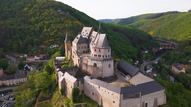 upper rooftop vianden castle chateau de historic site including old windows domes flags big round arches glass reveals from pull side drone shot back luxembourg 