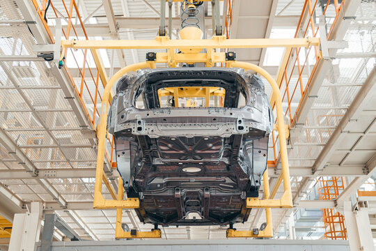 Automotive industry assembling conveyor line, car body suspended with bracket.